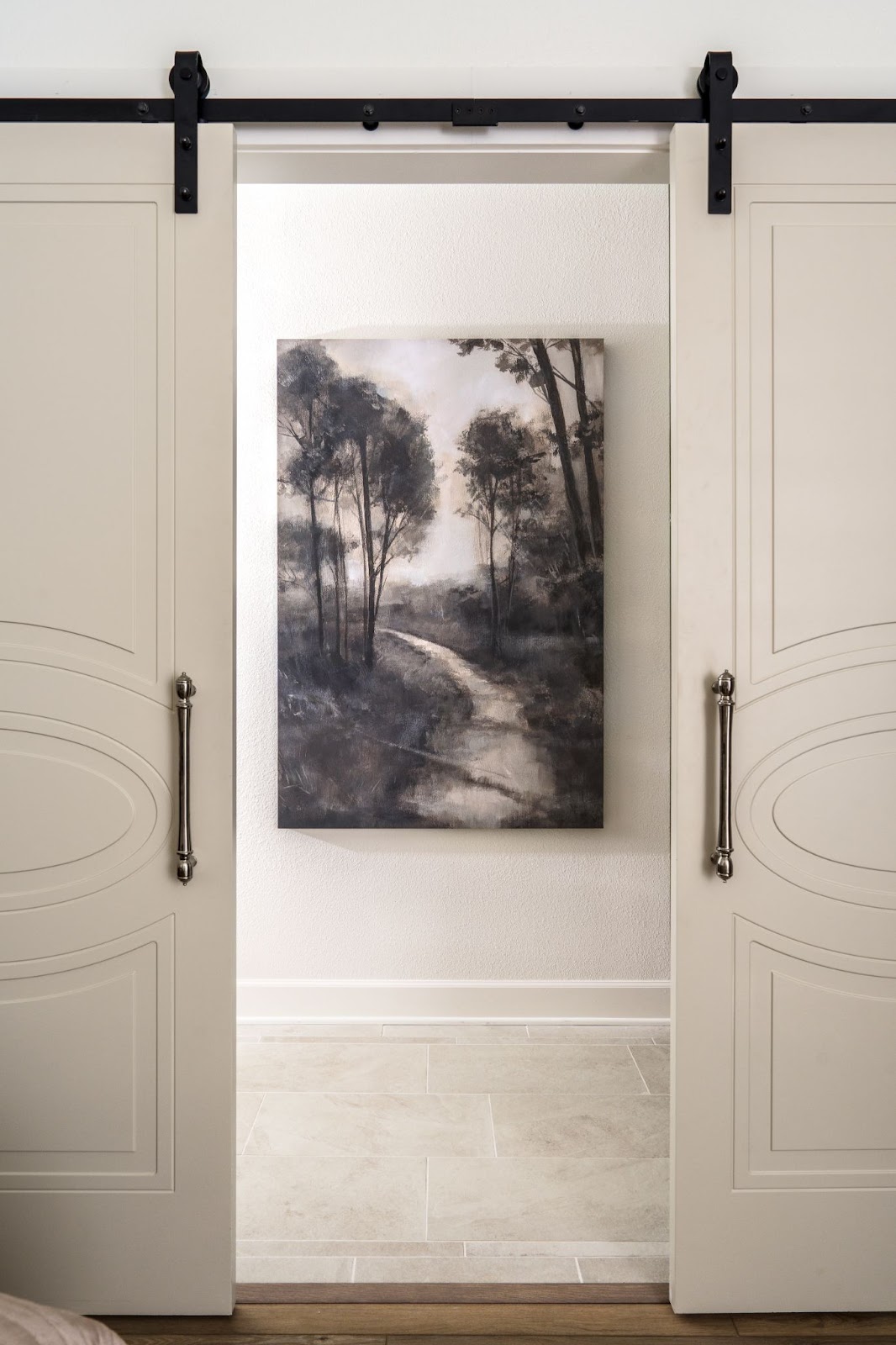 Photo from Texas interior design project showing a white wall with black artwork showing the best height to hang a picture