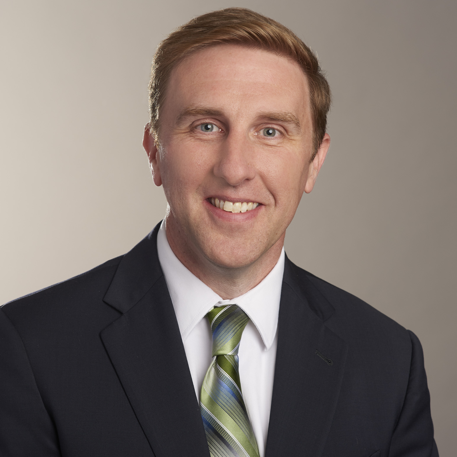 A person in a suit and tie

Description automatically generated