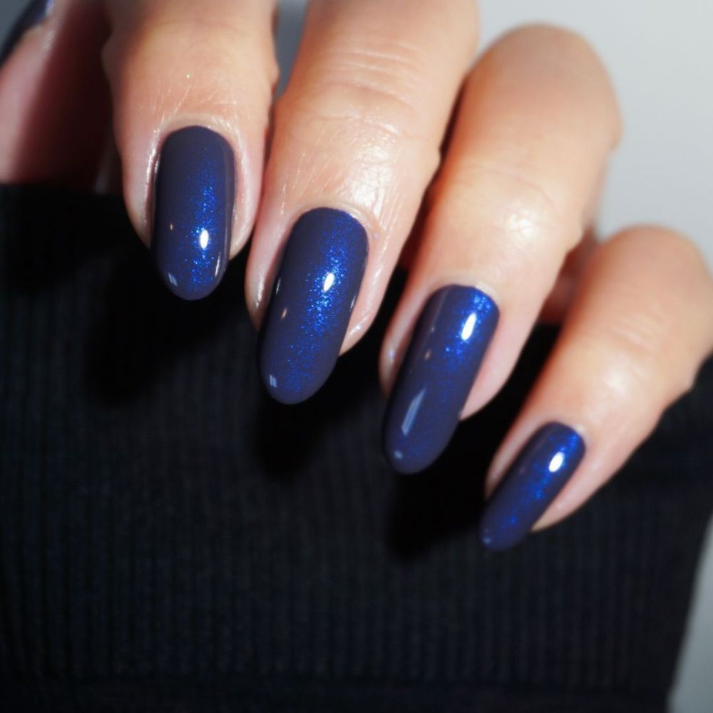 Close up of hands with blue winter nails having Dark Blue Nails