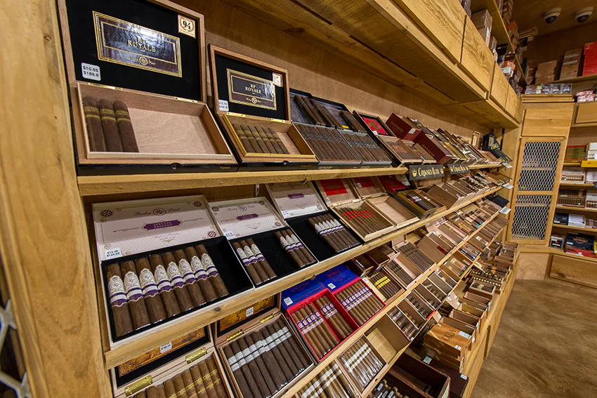 Premium cigars displayed on shelves in a cigar shop