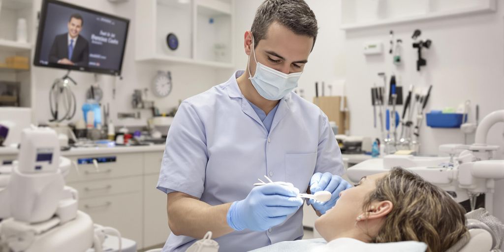 Dentist examining a patient in a bright clinic.