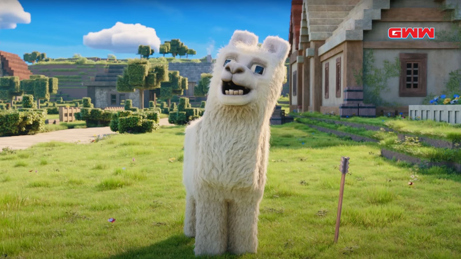 A llama standing in a grassy field, smiling in the Minecraft movie.