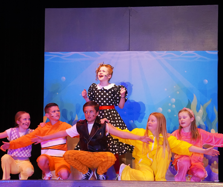Students performing a song in the musical performance of Finding Nemo.