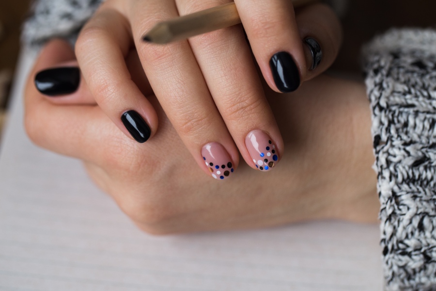 Scattered dots create a playful variation of French nail tip design.