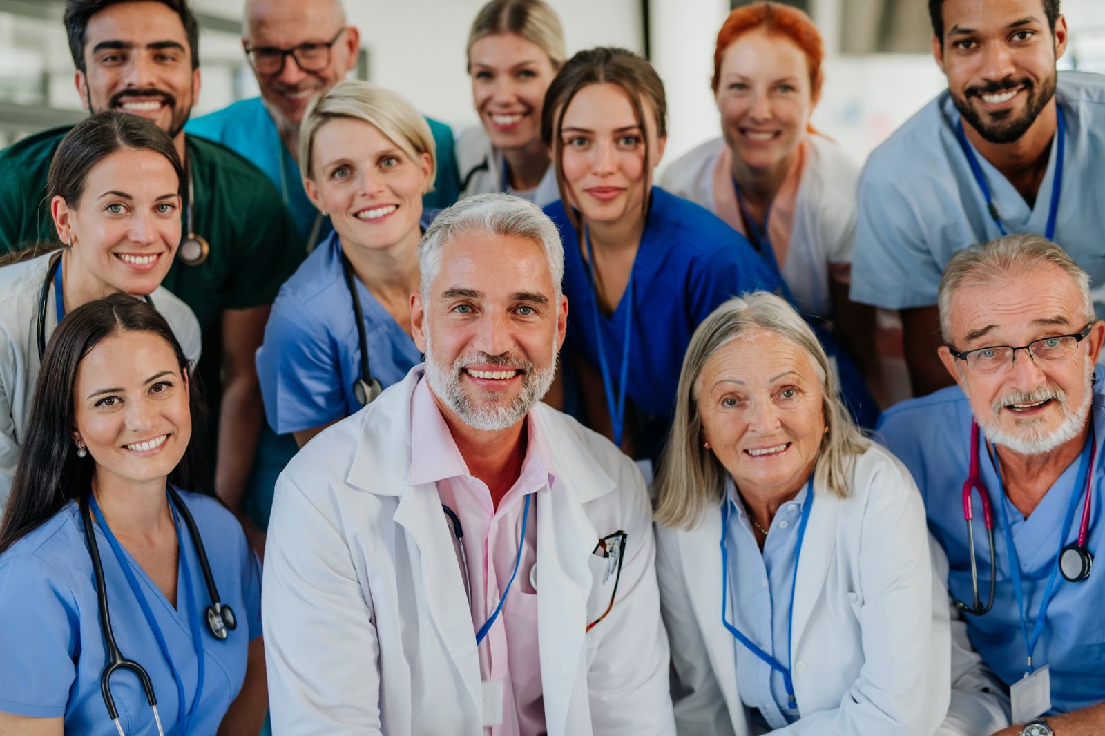 Male and female doctors and nurses sitting side-by-side. 