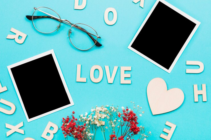 The word love written in white over a blue background with glasses, flowers and polaroid images