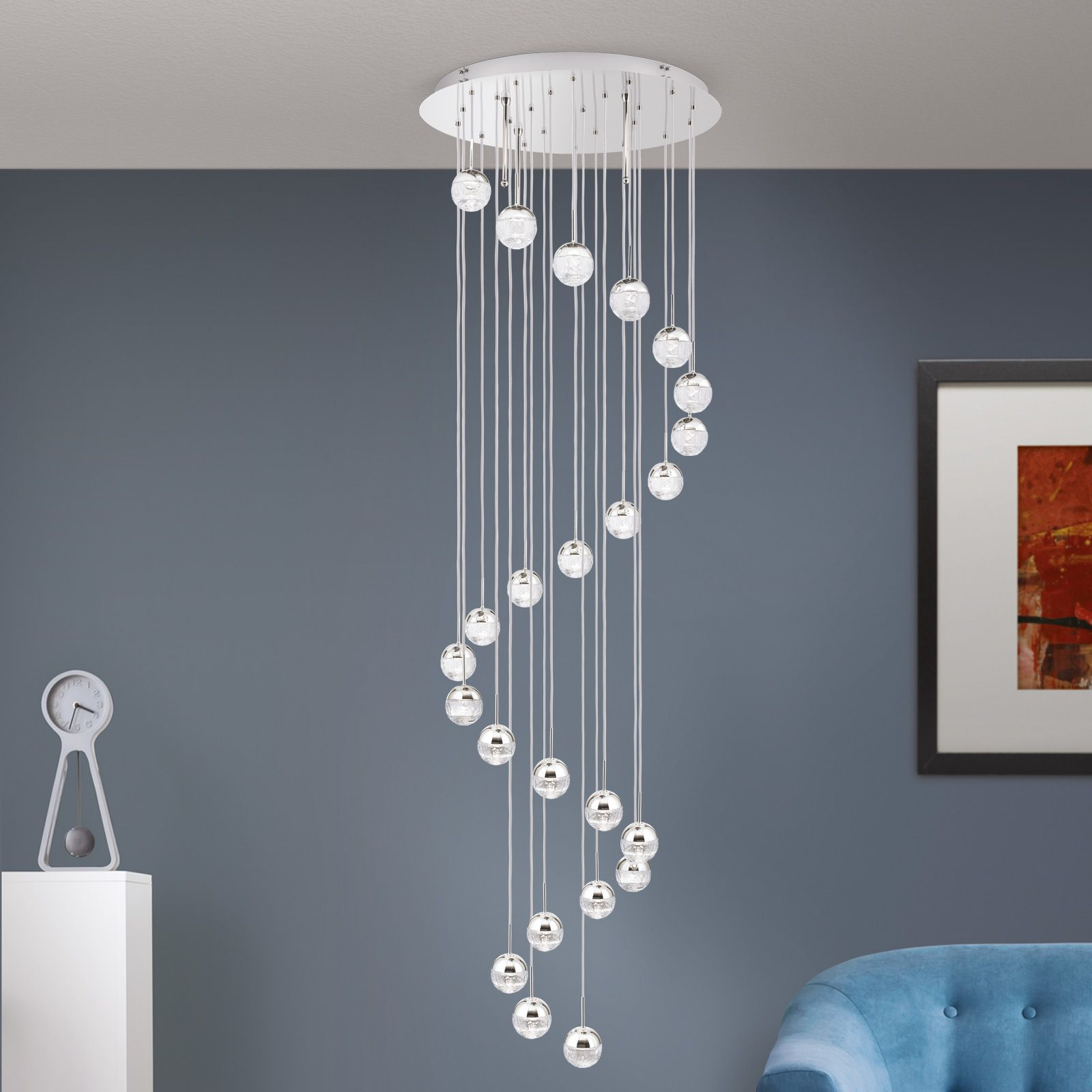 Thanks to its gold globe design and artistic lighting capabilities, the spiral chandelier elegantly connects two penthouse levels.
