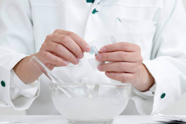 A pharmacist in a white coat carefully preparing compounded testosterone in a clinical compounding lab, showcasing precision and expertise.