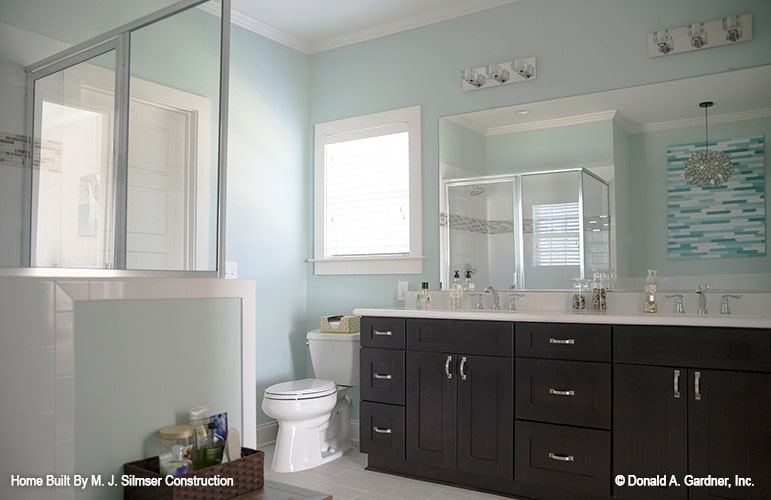 Toilet and double sink vanity complete the primary bathroom.
