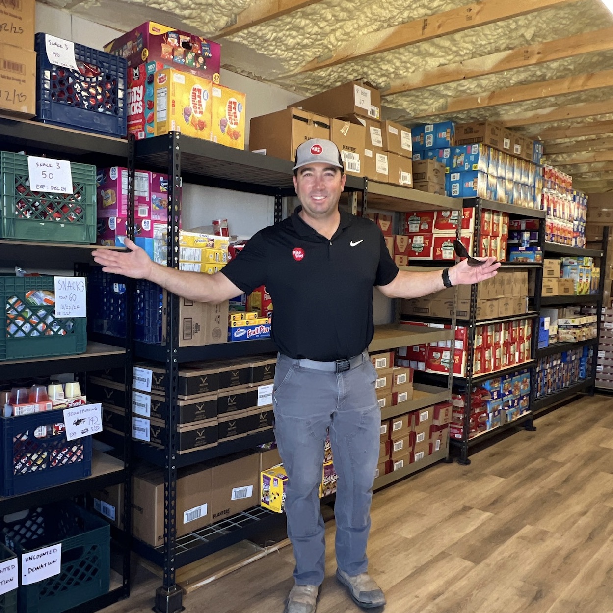 Standing with donated food.