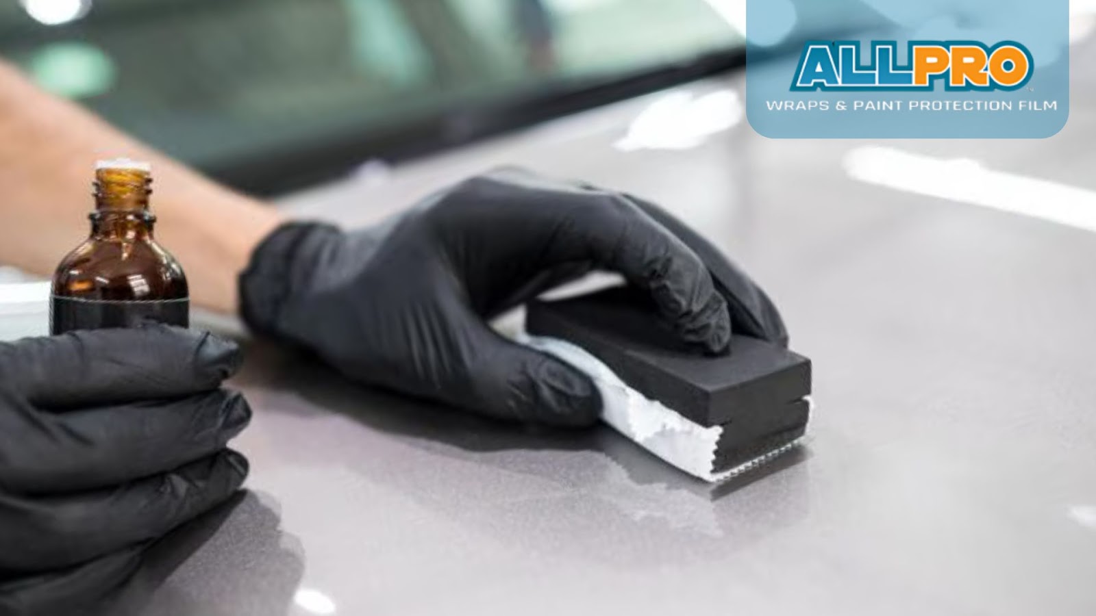 ceramic coating tools and supplies set up on a car hood