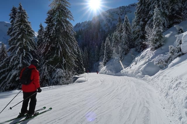 man skiing down flat groomed pistes