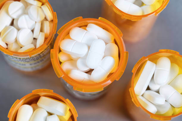 A close-up view of various compounded pain medications in different bottles, showcasing customized formulations for personalized pain relief.