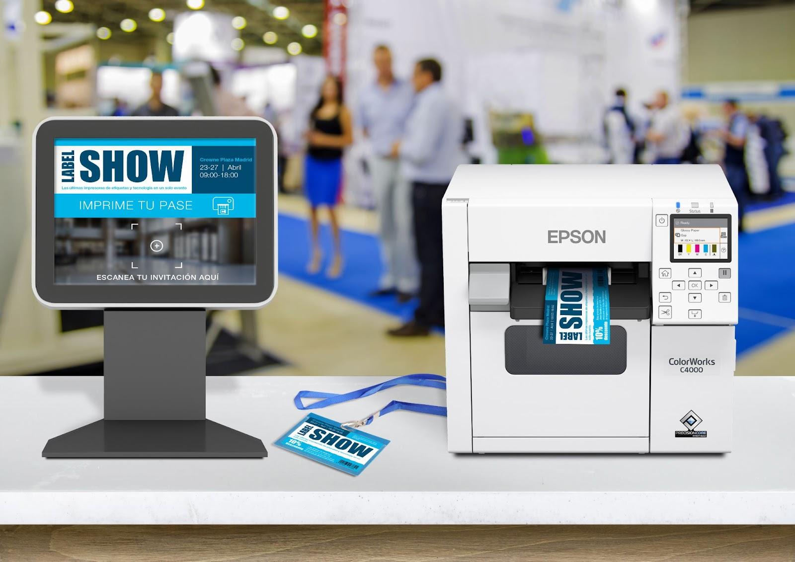An Epson ColorWorks C4000 label printer is being used to print badges, with a digital display showing the event information