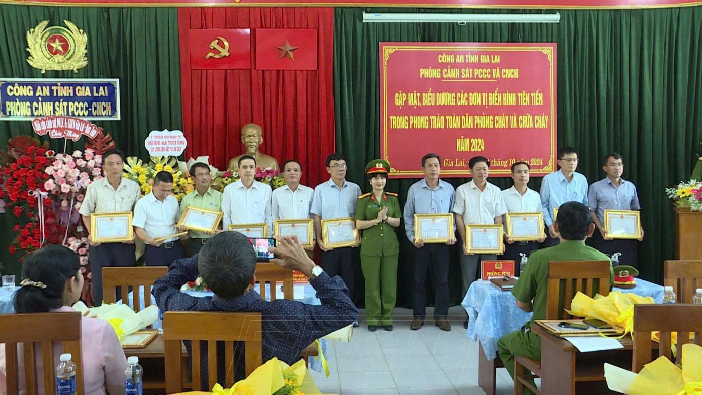 A group of people in uniform standing in a roomDescription automatically generated