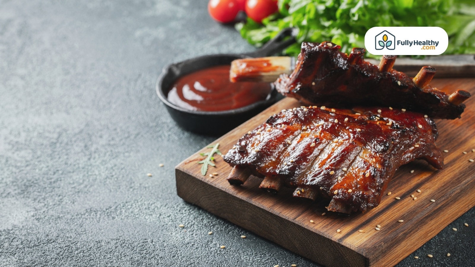 Barbecue ribs on wooden board with sauce and fresh greens