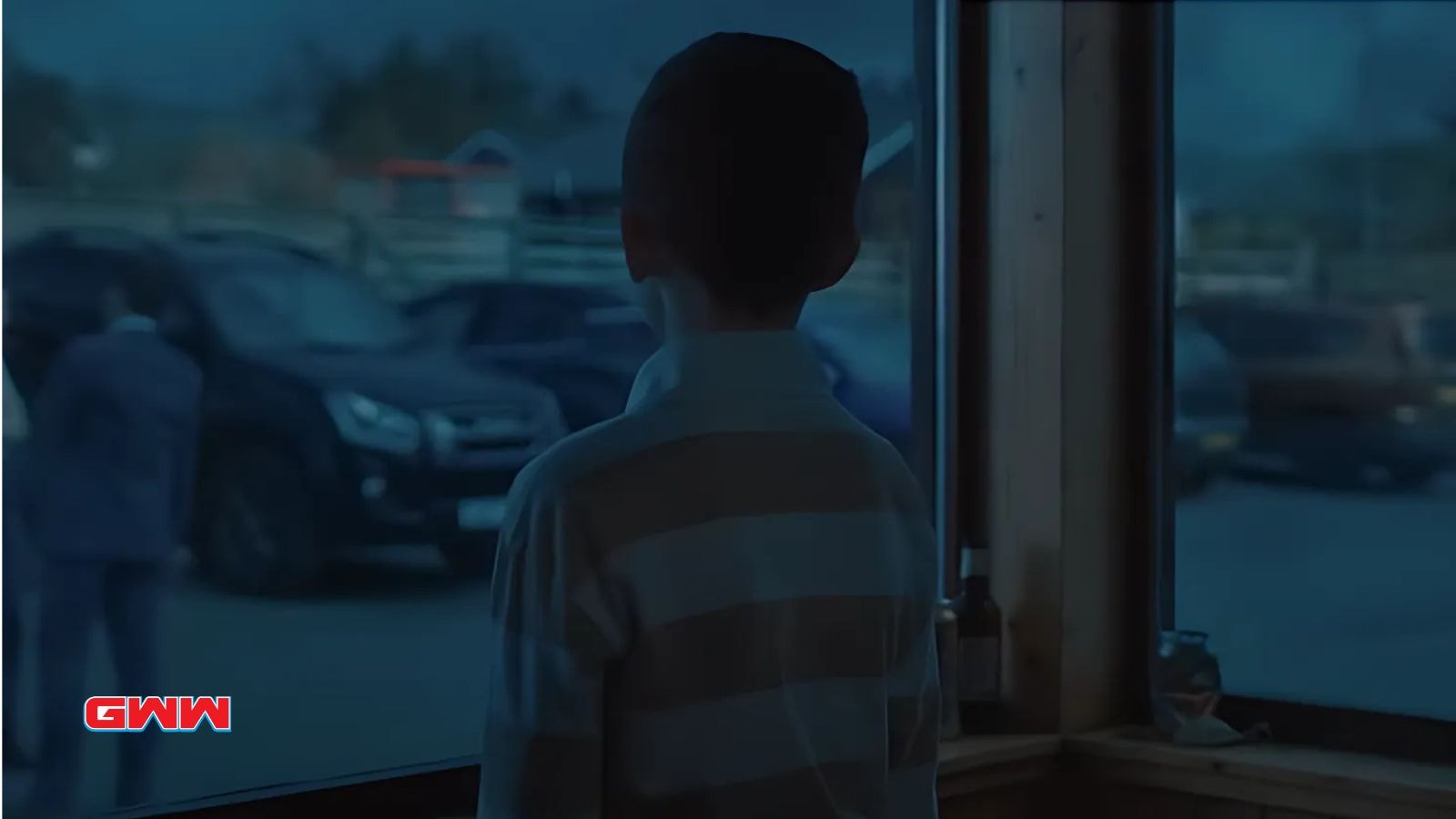 Young boy staring out the window in a mysterious Shetland scene