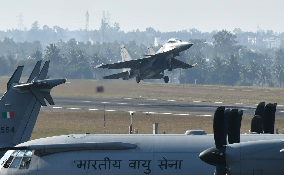 A jet flying over a runwayAI-generated content may be incorrect.