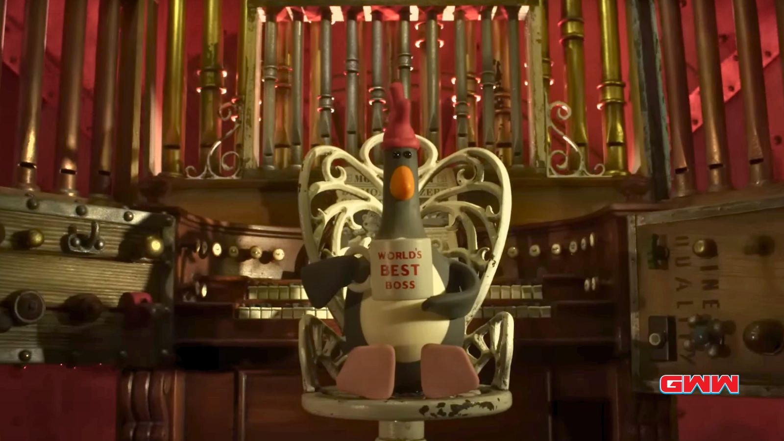 Feathers McGraw sits in a dark room with “World’s Best Boss” mug.