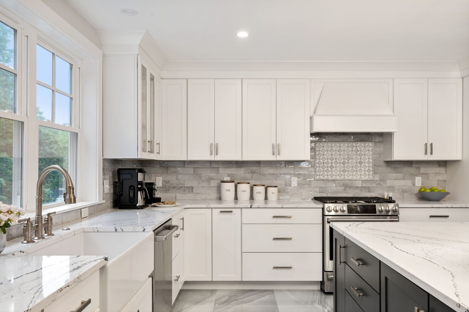 This image depicts a kitchen area featuring shaker cabinets and stainless steel appliances.