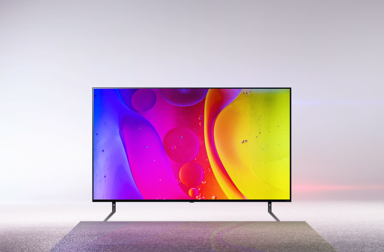 A TV in a stark white room displays bright, hypnotic moving colors on the screen.