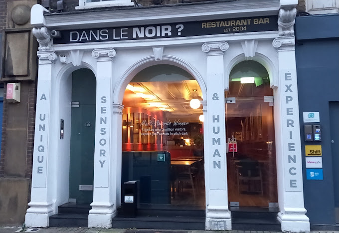 Dining experience at Dans Le Noir in London, where guests enjoy gourmet meals in complete darkness for a unique sensory adventure