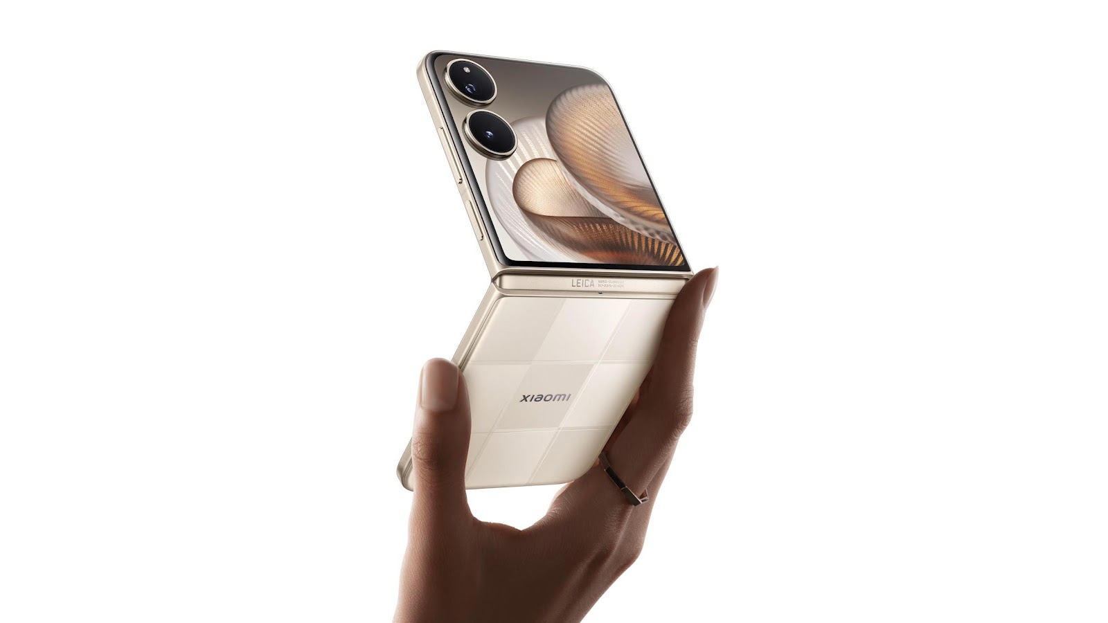 A hand is holding a flip phone, the front screen displays a unique pattern, and the back has the Xiaomi logo and the word Leica.