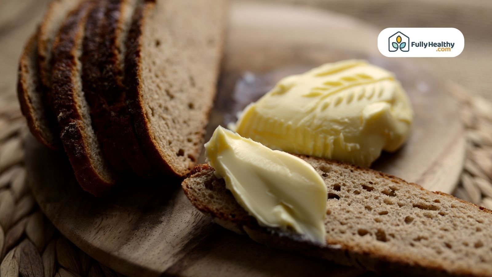 Sliced bread with butter on wooden board from FullyHealthy website