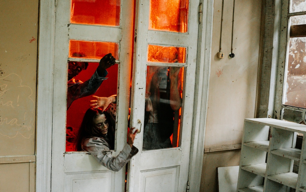 people dressed in scary costumes inside haunted house