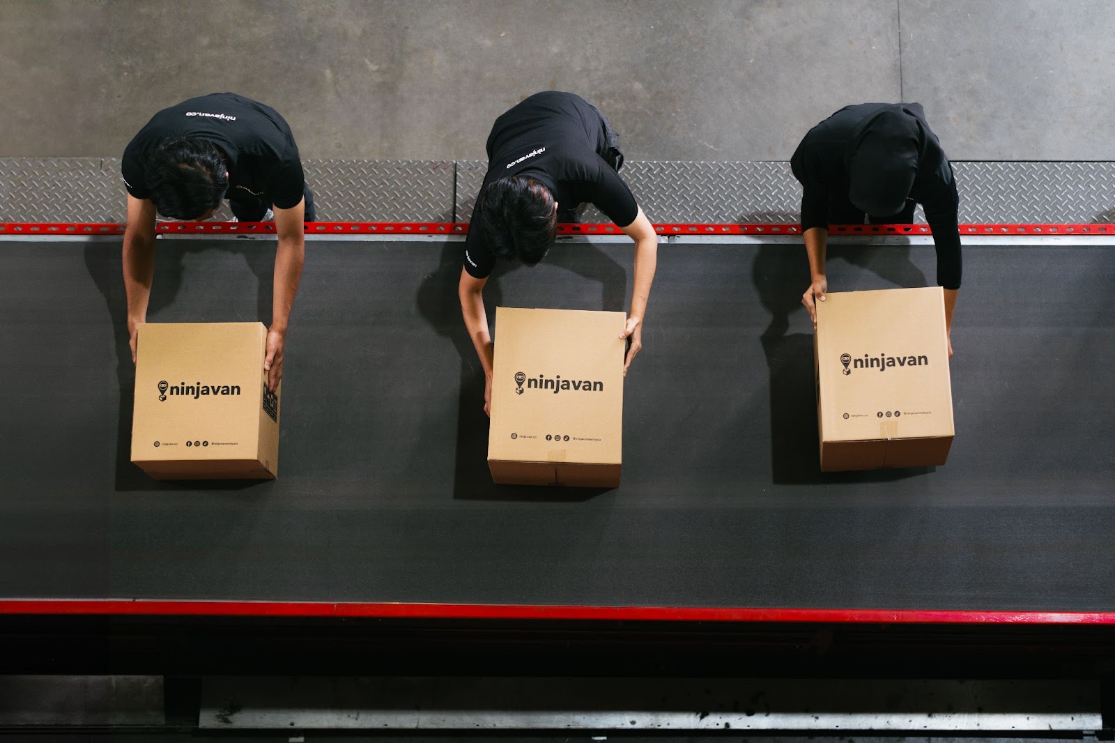 Packing team preparing FMCG items in boxes for customer orders.