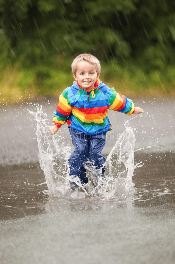 Rain photoshoot featuring a child playing in rain.