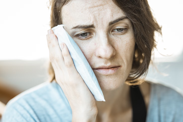woman with ice pack on face
