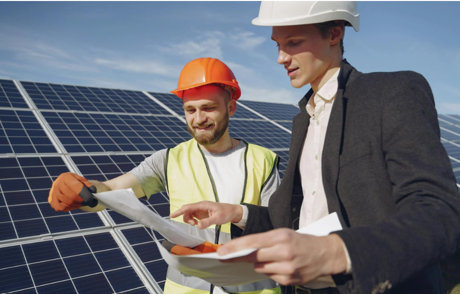 Two workers sharing enjoyable work in the building materials industry designing and installing solar panels