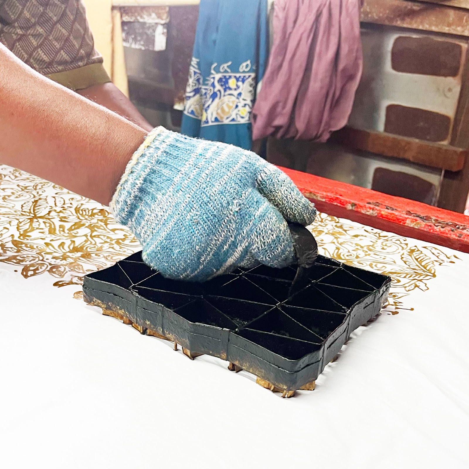 An image showing traditional batik first process, call batik cop it's in floret print.