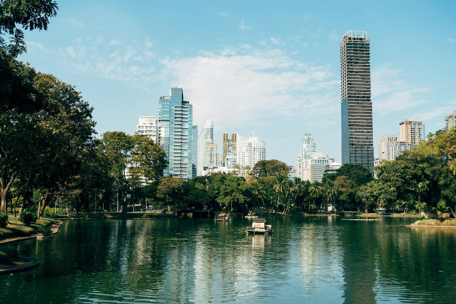 A body of water with trees and buildings in the background

Description automatically generated