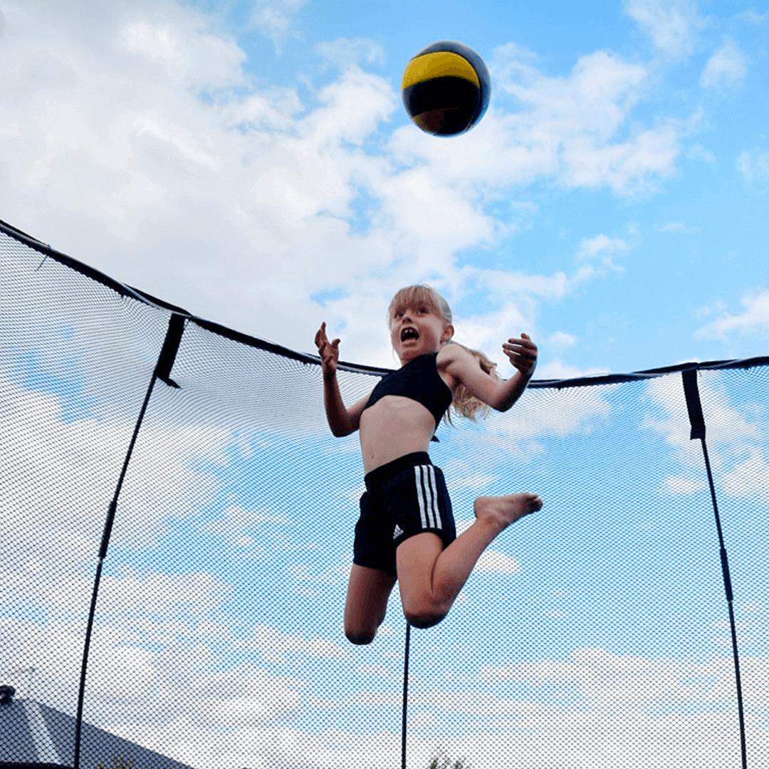 Little Girl Playing with a Ball on Trampoline - supertramp.co.uk