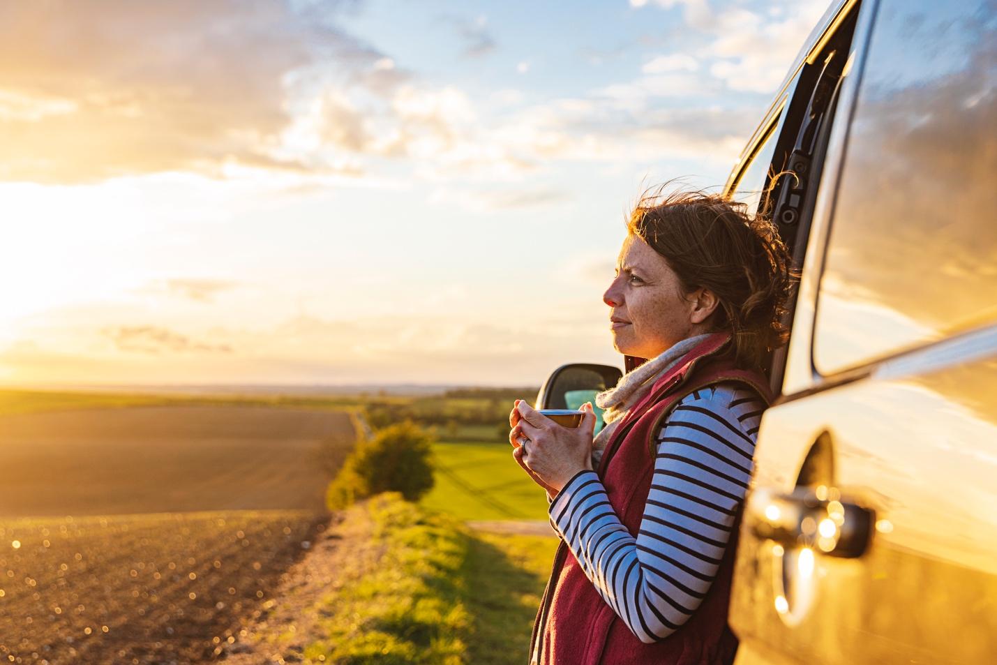 Woman looking at scenic view from van