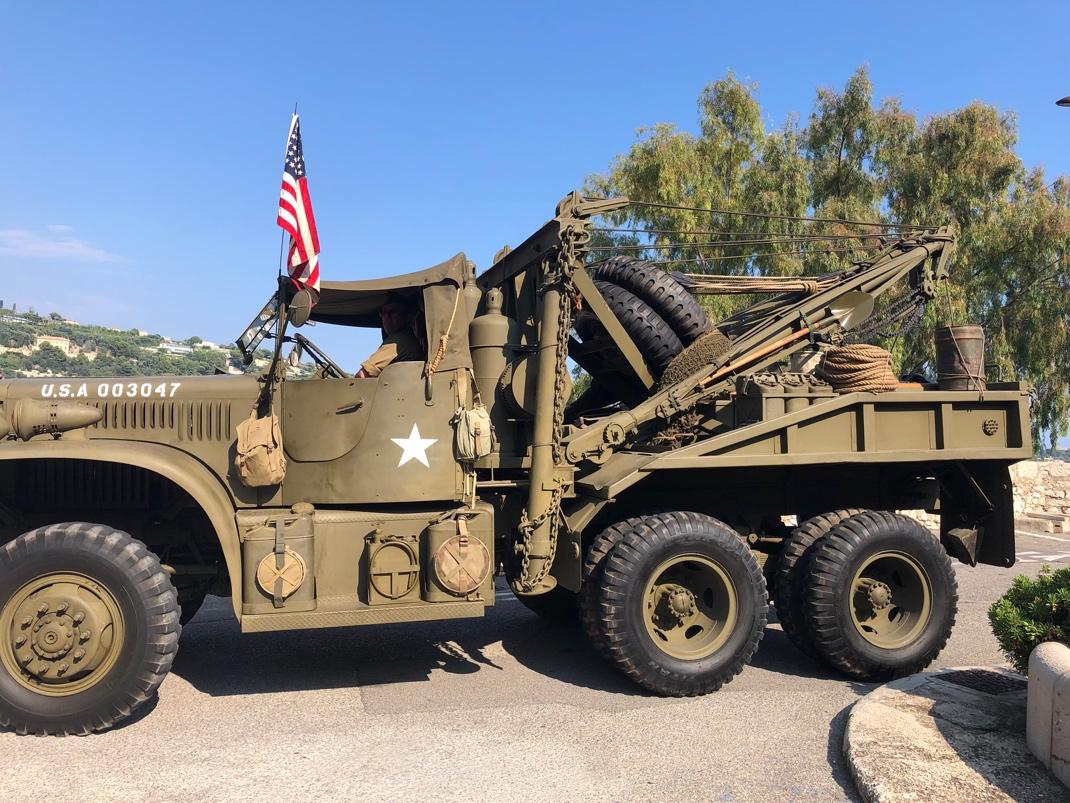 A military truck with a flag on the side

Description automatically generated