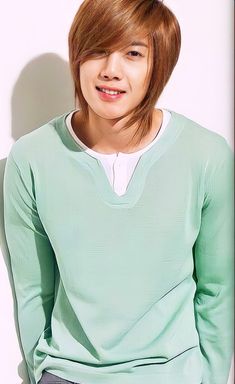 This contain an image of  Kim Hyun Joong wearing a green sweater 