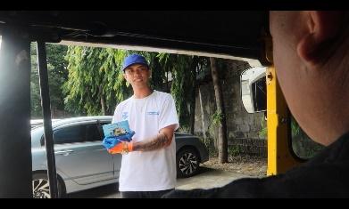 A person in a blue hat holding a blue object