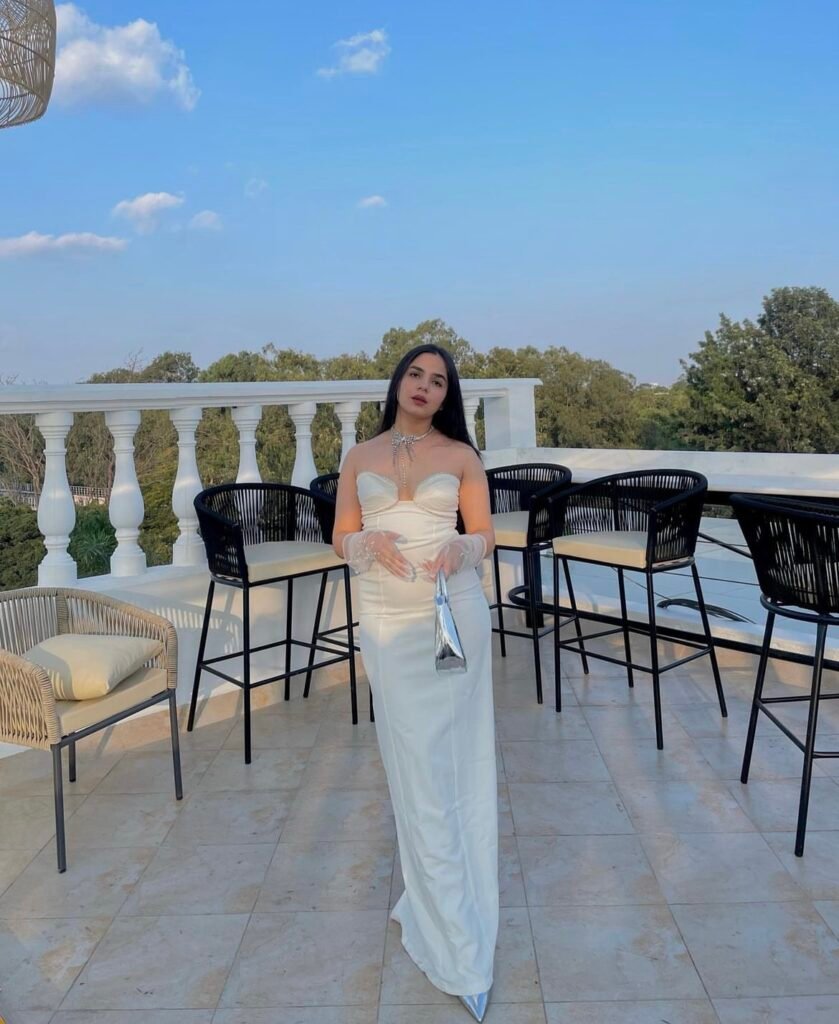 A woman wearing a white bustier dress.