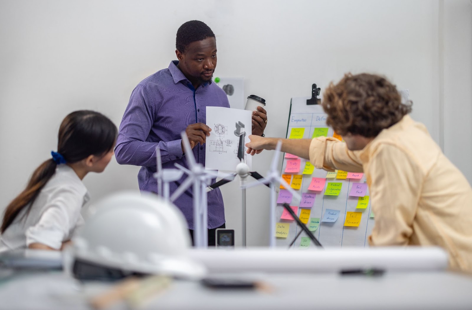 Engineers discussing technical product designs and concepts in a workspace