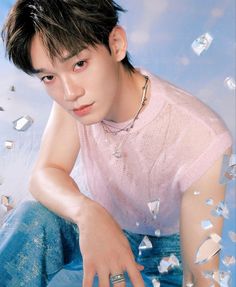 This contains an image of  EXO's Chen
 sitting on the ground surrounded by confetti and glass cubes