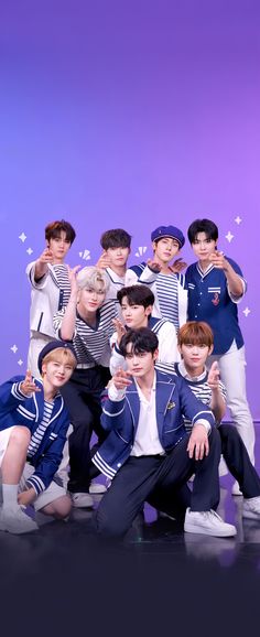 This contains an image of ZEROBASEONE members posing for a photo in front of a purple background with blue and white stripes