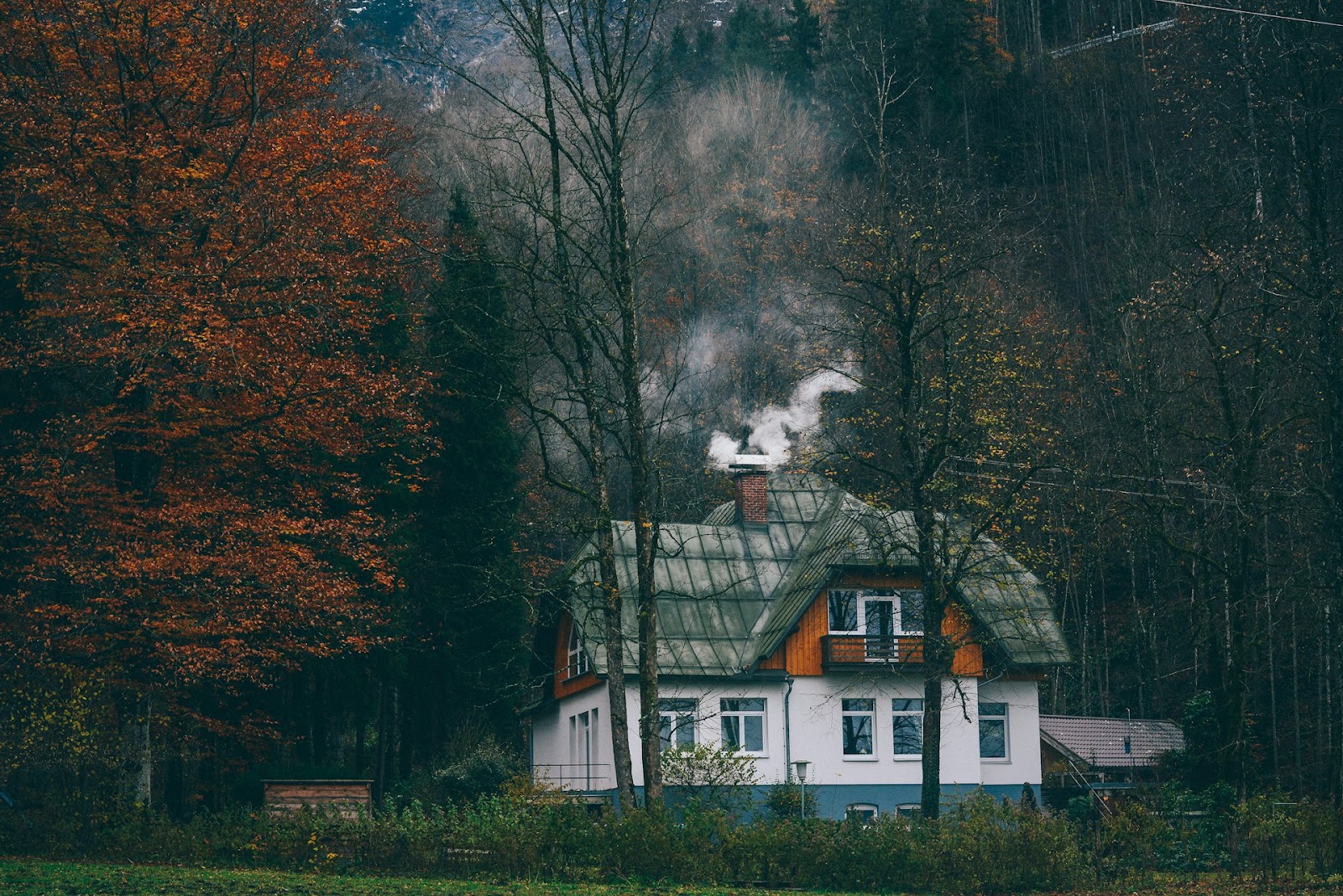 House emitting smoke through the chimney.