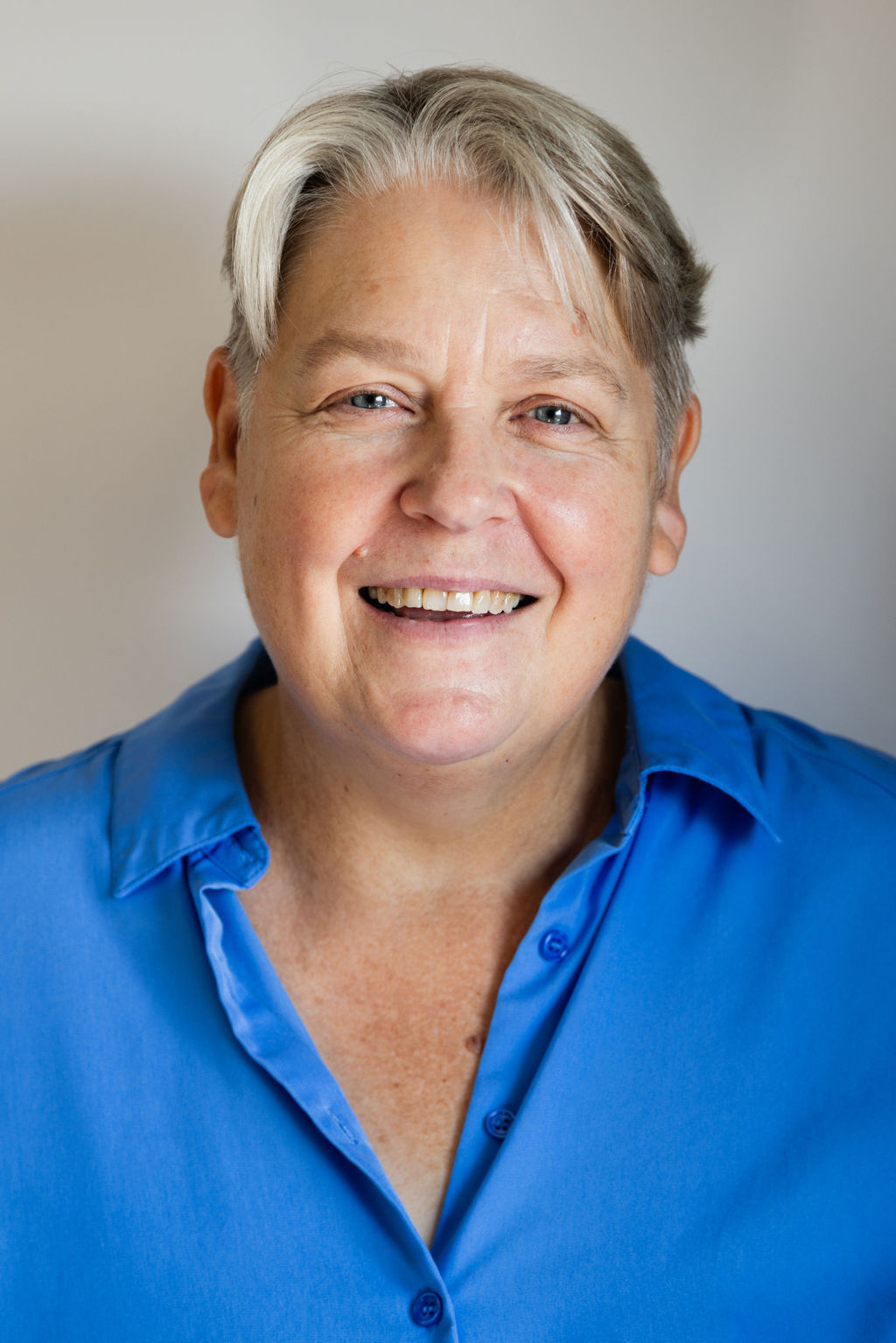 Headshot of Kate Barker. She smiles at the camera. 