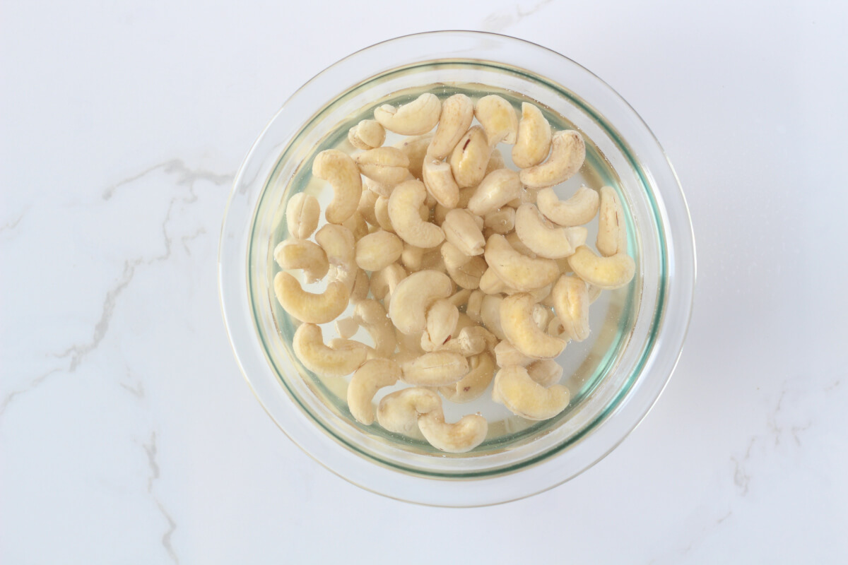 Soaking cashews in bowl of hot water