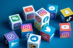 This containsan image of colorful cubes with social media icons on them are arranged in the shape of squares