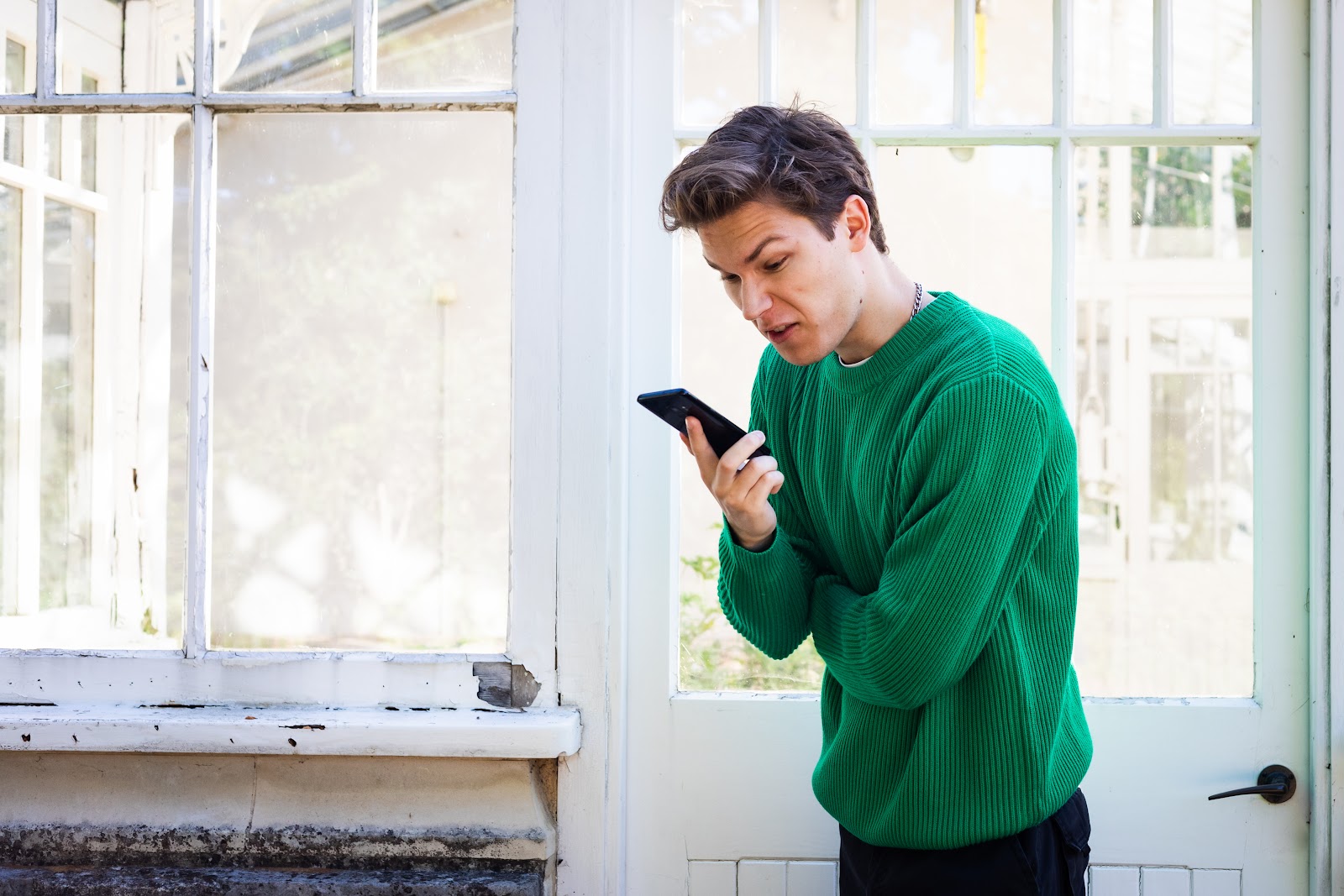 Angry man looking at phone | Source: Shutterstock