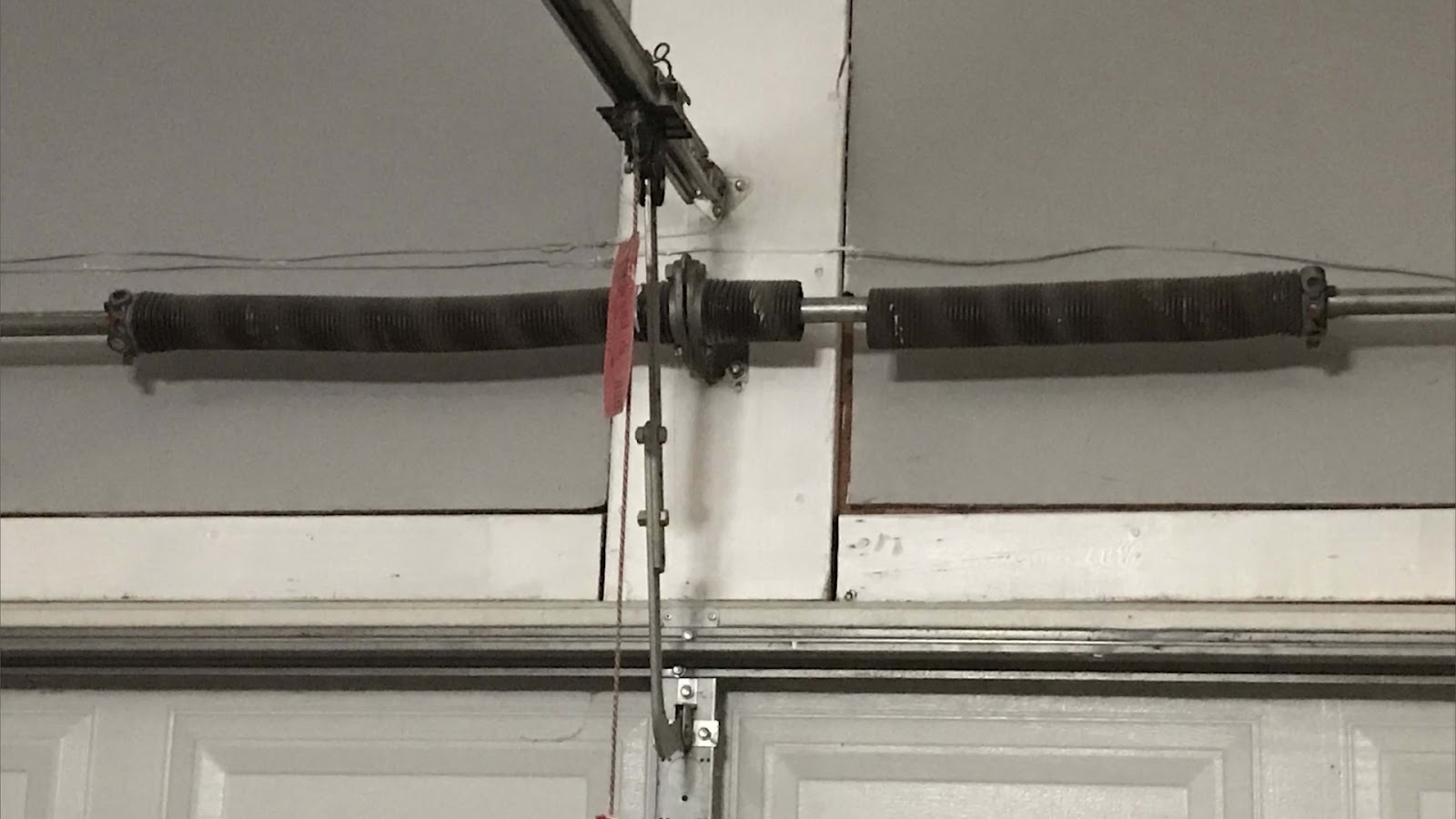 A stuck garage door stuck due to a broken torsion spring